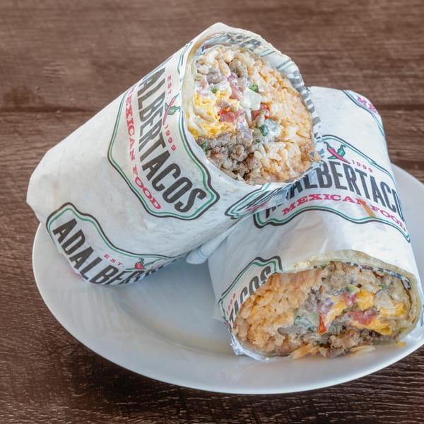 Two Adalbertacos Mexican Food burritos, unwrapped to show rice, meat, cheese, and salsa.