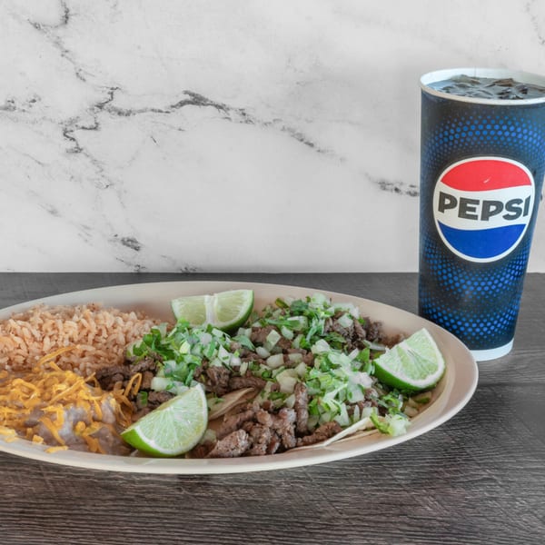 Adalbertacos Mexican Food plate with carne asada tacos, rice, beans, and a Pepsi.