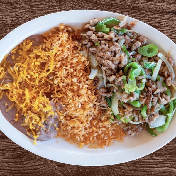 Adalbertacos Mexican Food plate with rice, refried beans with cheese, and fajita meat with peppers.